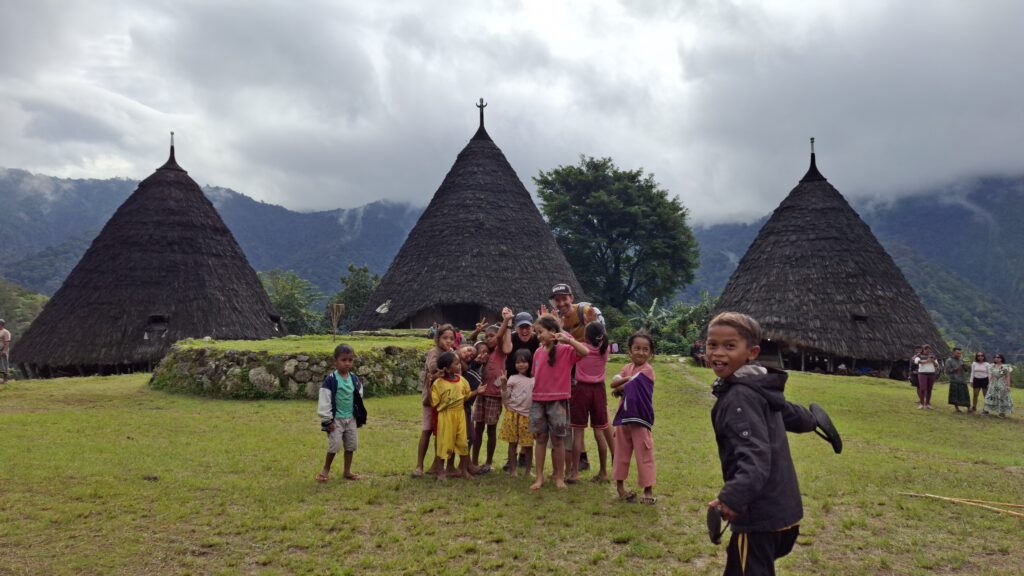 kids in wae rebo traditional village enjoy their holiday with visitors